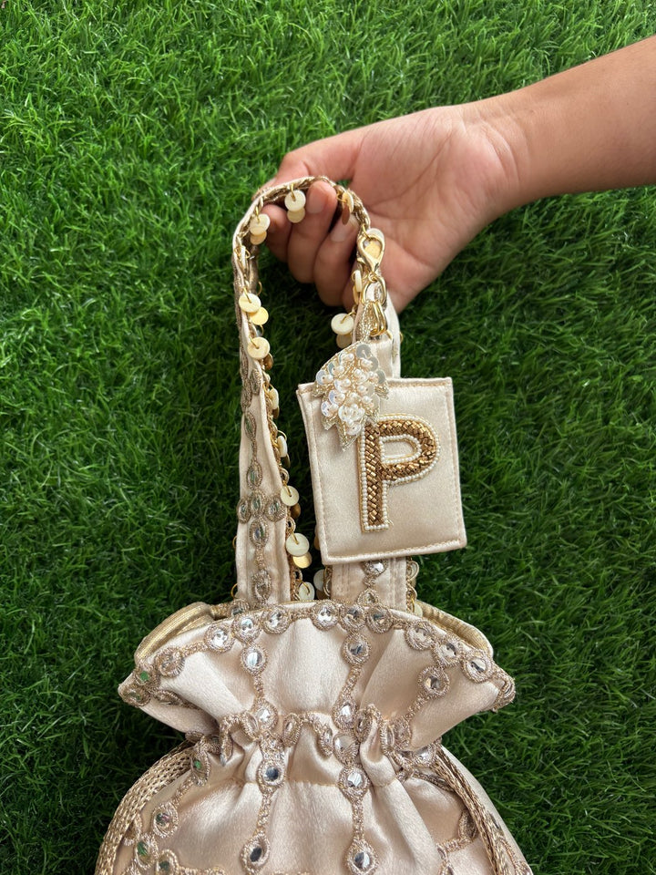 Royal Cutwork Gold Potli with Customised Initial Charm