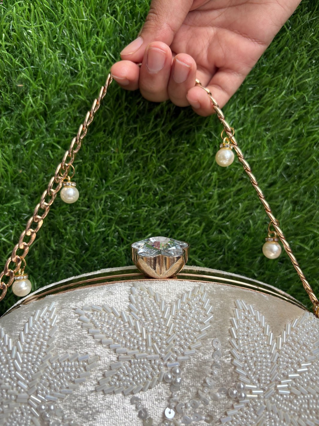 Close-up of floral cutdaana detailing on an ethnic clutch bag