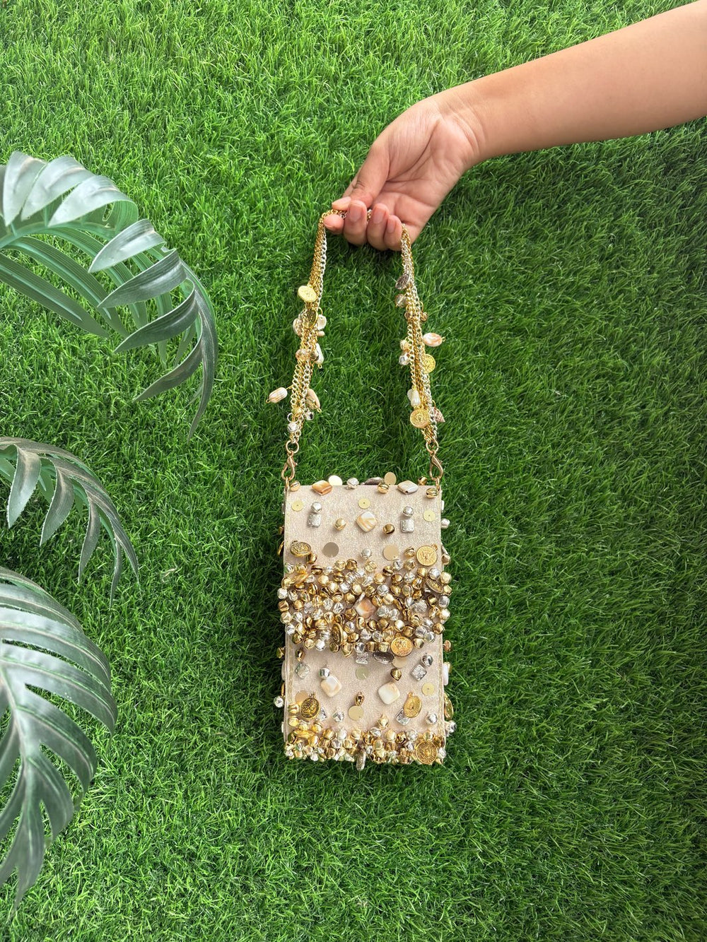 Golden designer mobile sleeve with ghungroo work by The Potli Ghar