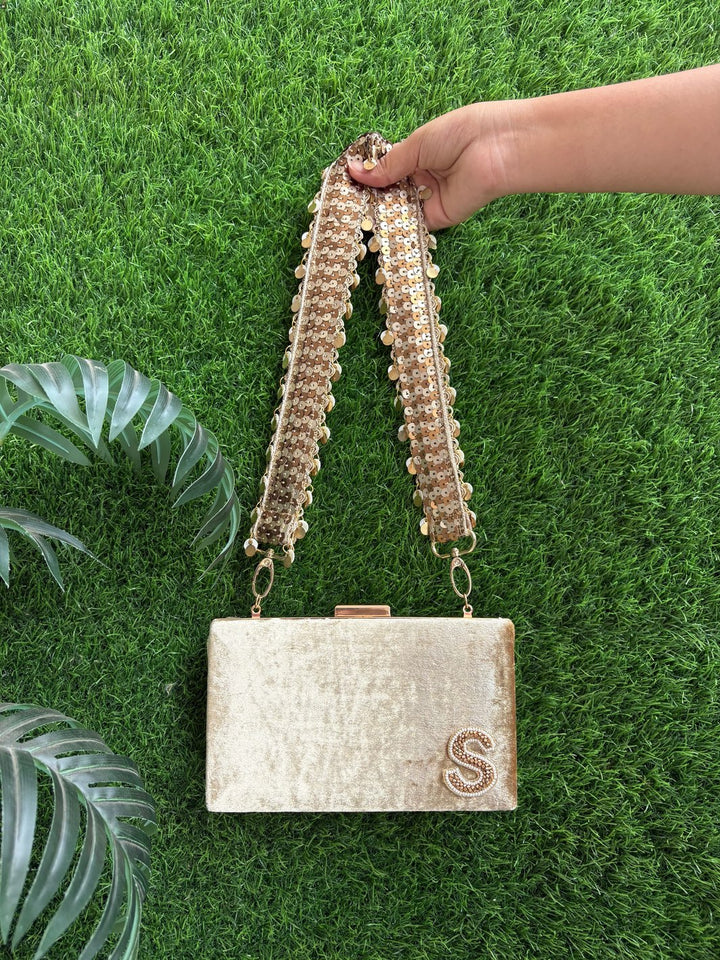 Designer golden clutch bag with decorative sequin belt detailing