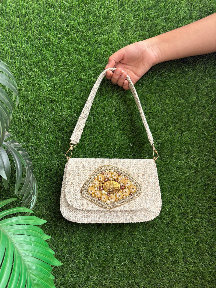 Designer ivory evening clutch with antique gold floral detailing