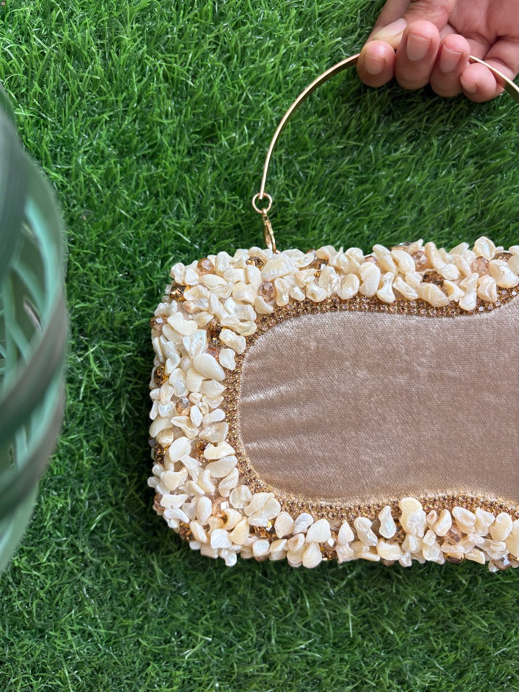 Light golden embellished clutch showing intricate shell detailing