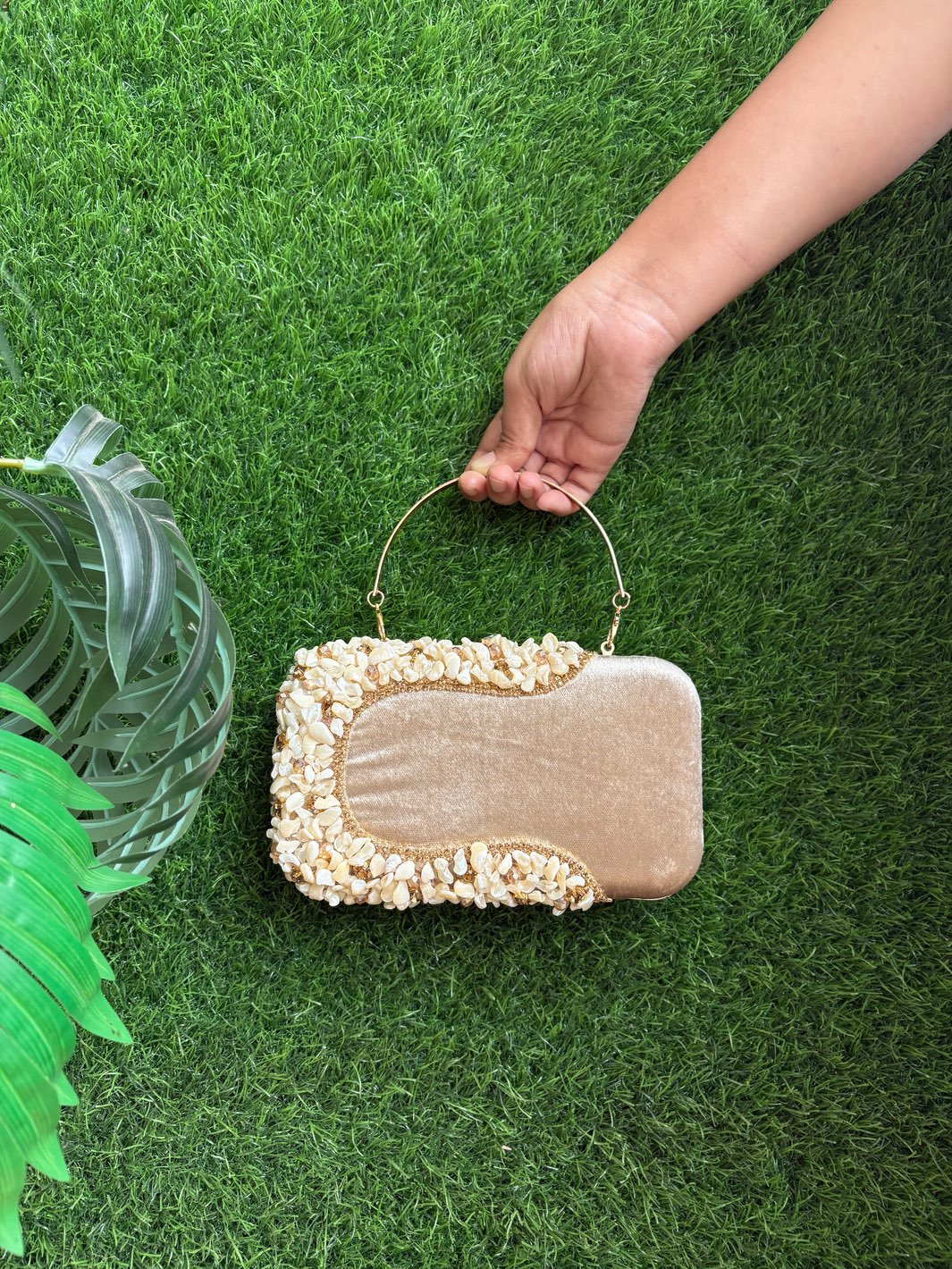 Light golden shell embellished clutch with structured design
