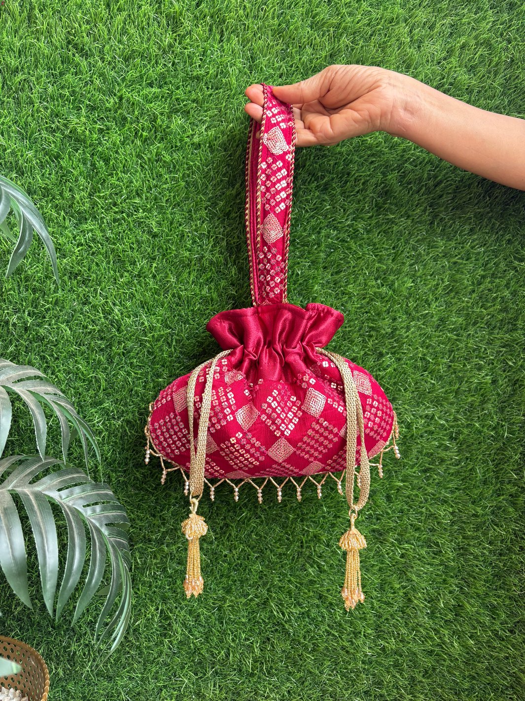 Dark red designer potli bag with elegant detailing