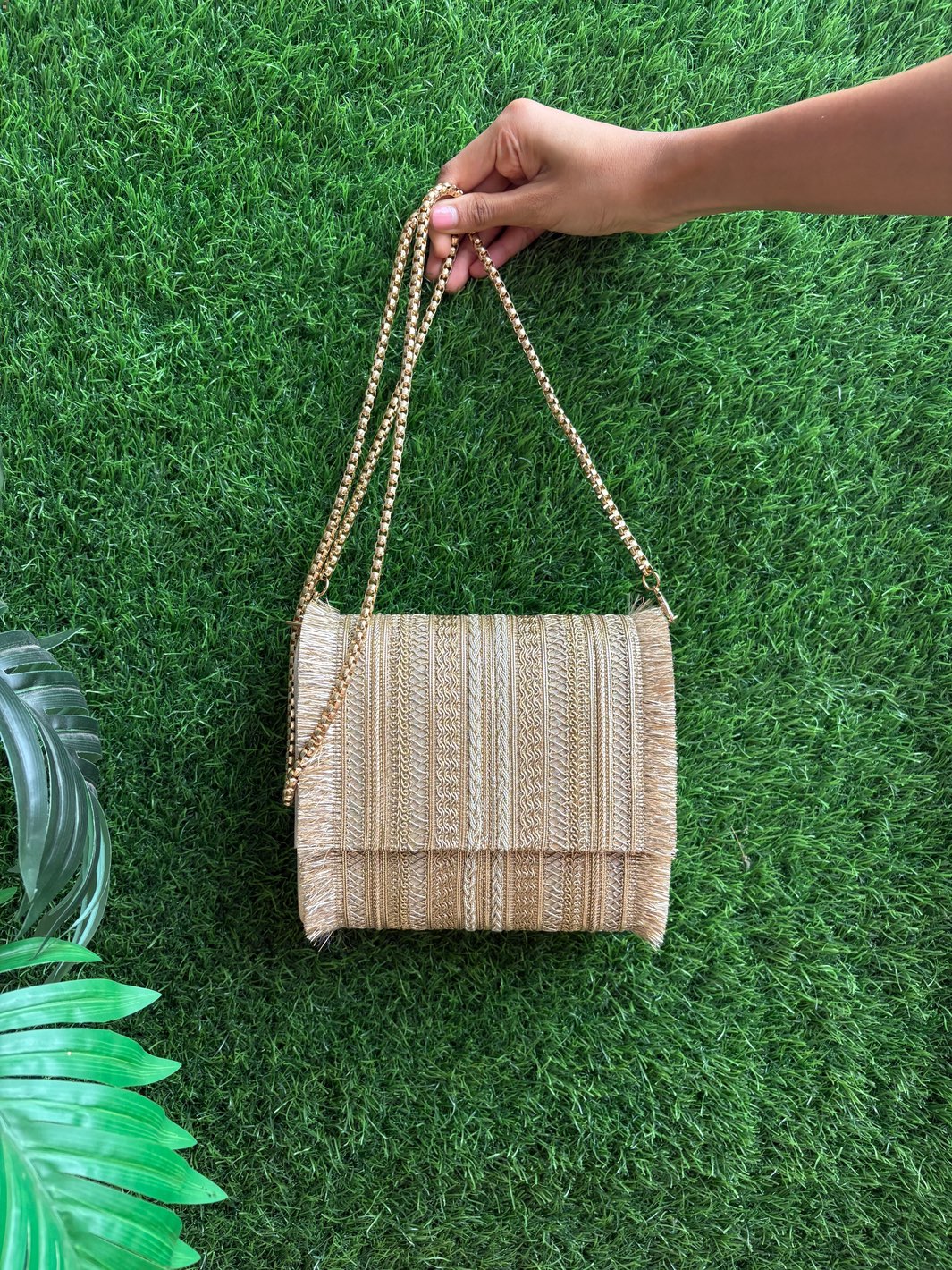 Embellished handle detail of Premium Gold Ethnic Clutch Bag