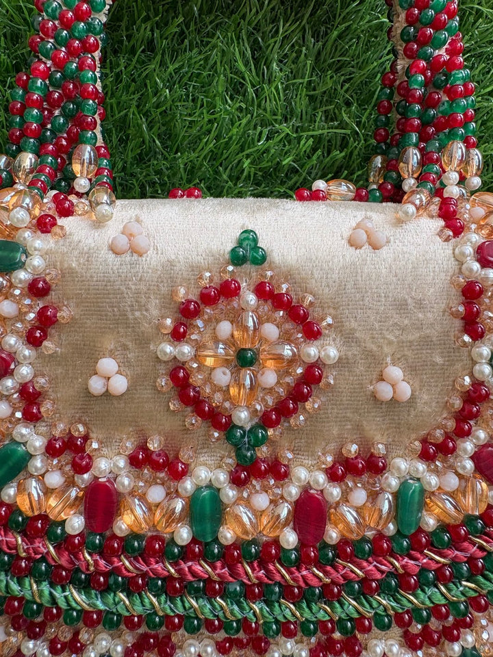 Designer ethnic clutch with red and green beadwork