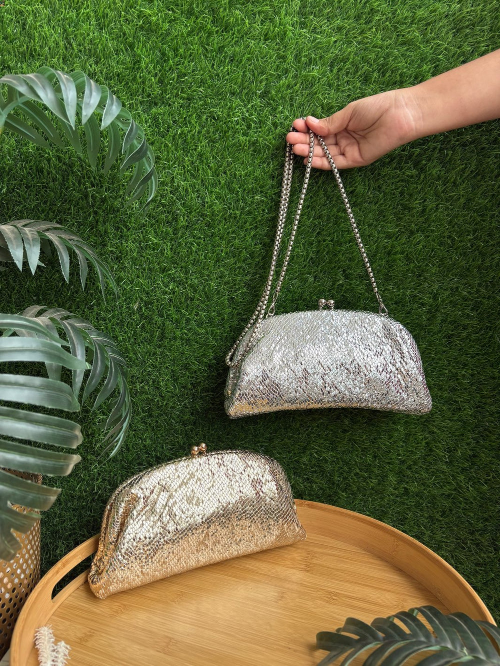 Golden textured ethnic clutch bag with metal half-frame closure