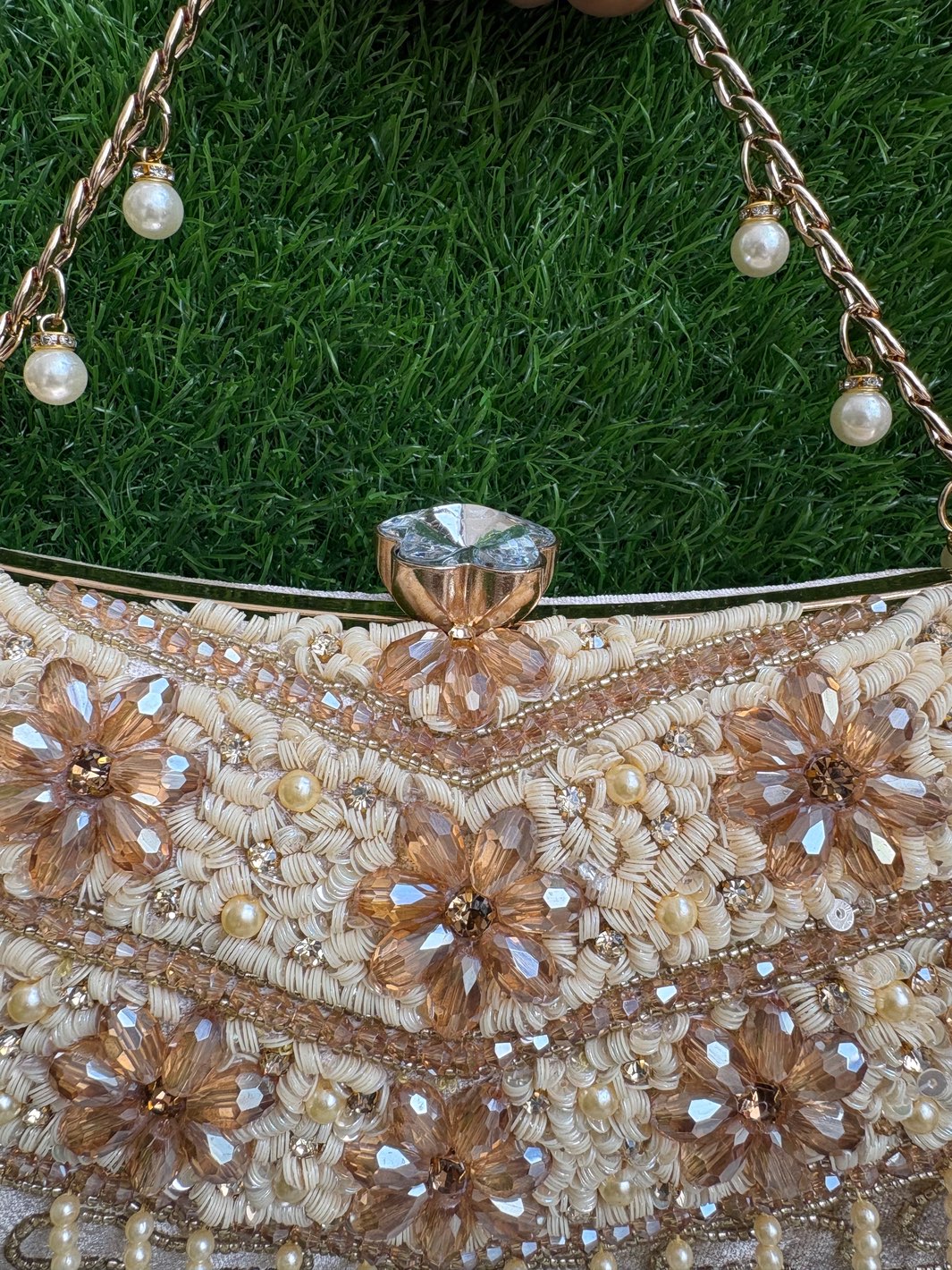Close-up of Crystal Bloom Clutch floral crystal embellishment and statement clasp