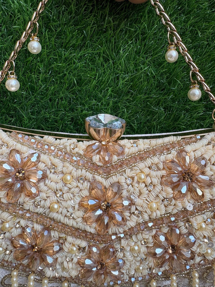 Close-up of Crystal Bloom Clutch floral crystal embellishment and statement clasp