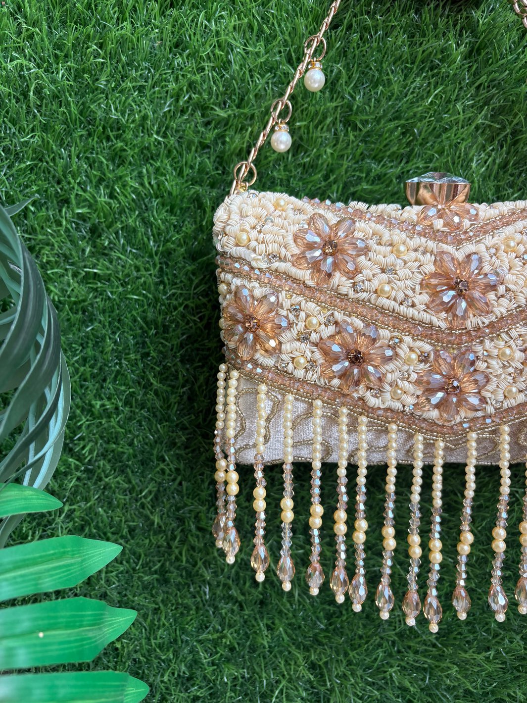 Close-up of Crystal Bloom Clutch floral crystal embellishment and statement clasp