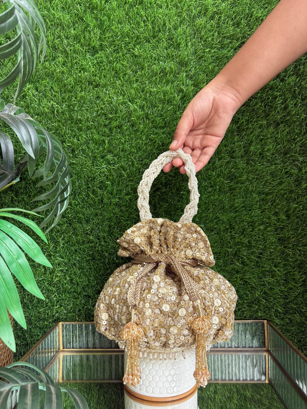 The Golden Affair Potli with pearl-adorned handle and gold embellishments