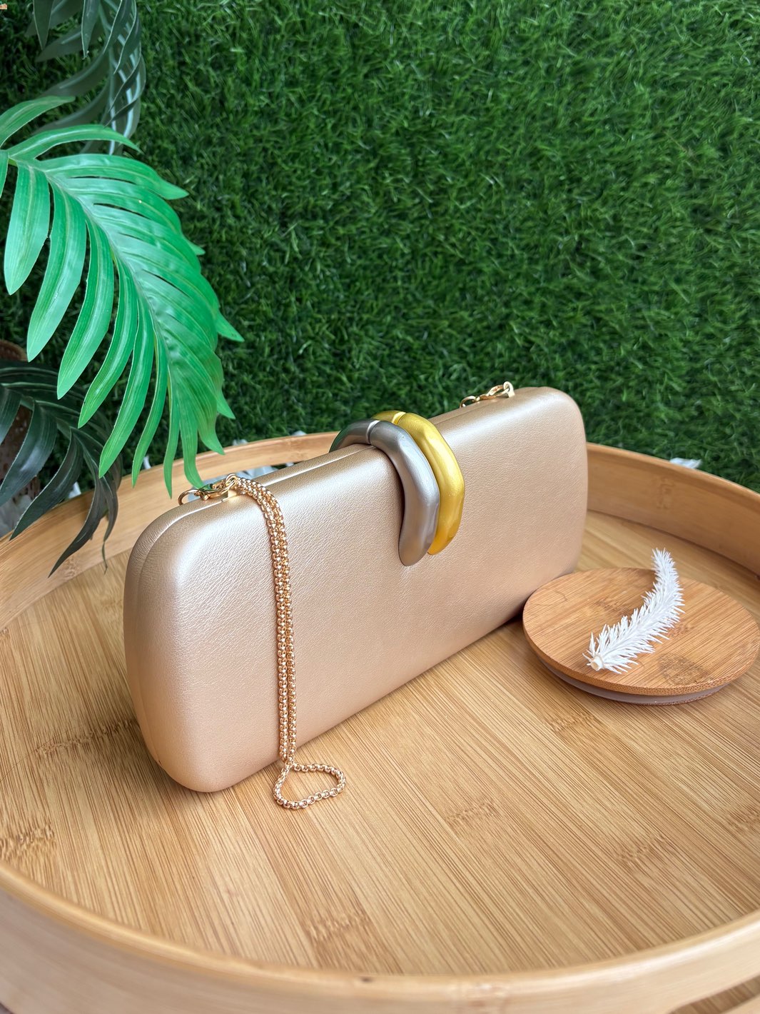Champagne gold clutch with interlocking gold and silver statement handle