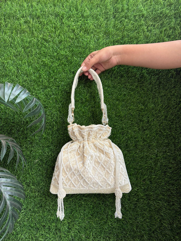 Traditional velvet potli purse for wedding and festive outfits in Ivory with crystal and cutdaana detailing
